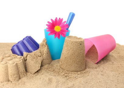 An image of a sand and a small bucket.