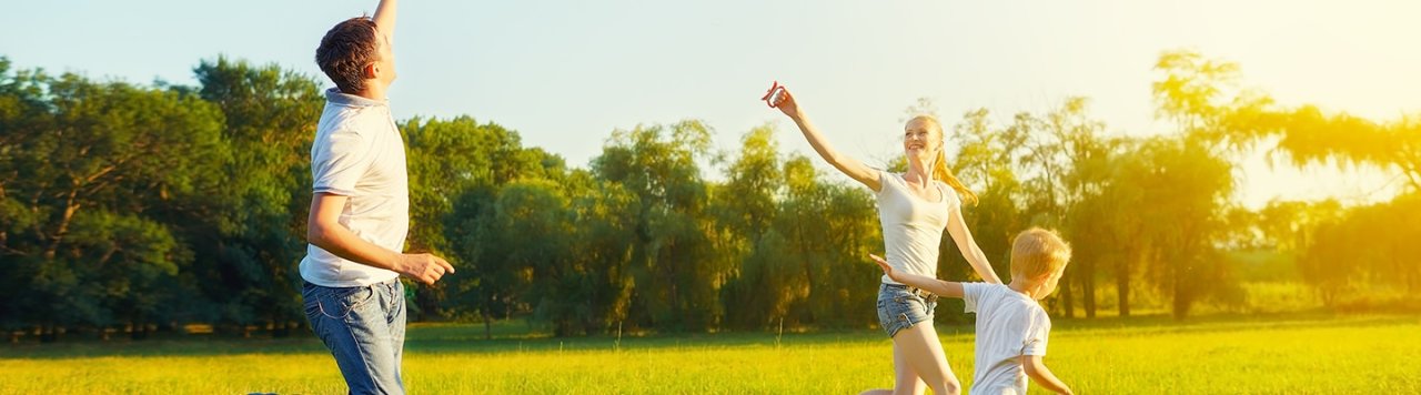 A happy family flying a kite in a park.