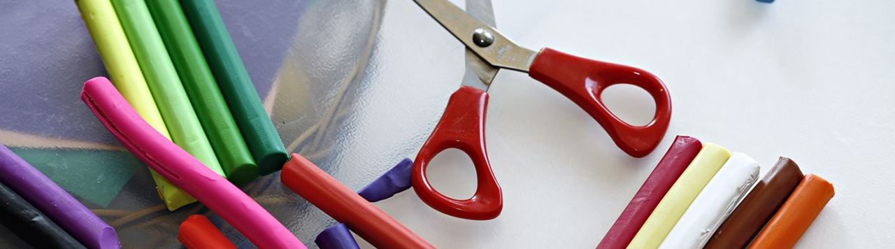 Colourful chalk and scissors sitting on a clear table, ready for crafts.