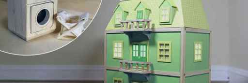 a green dollhouse with a play washing machine