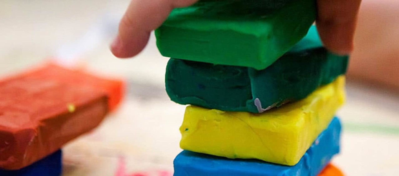 Squares of colourful playdough stacked up in a pile.