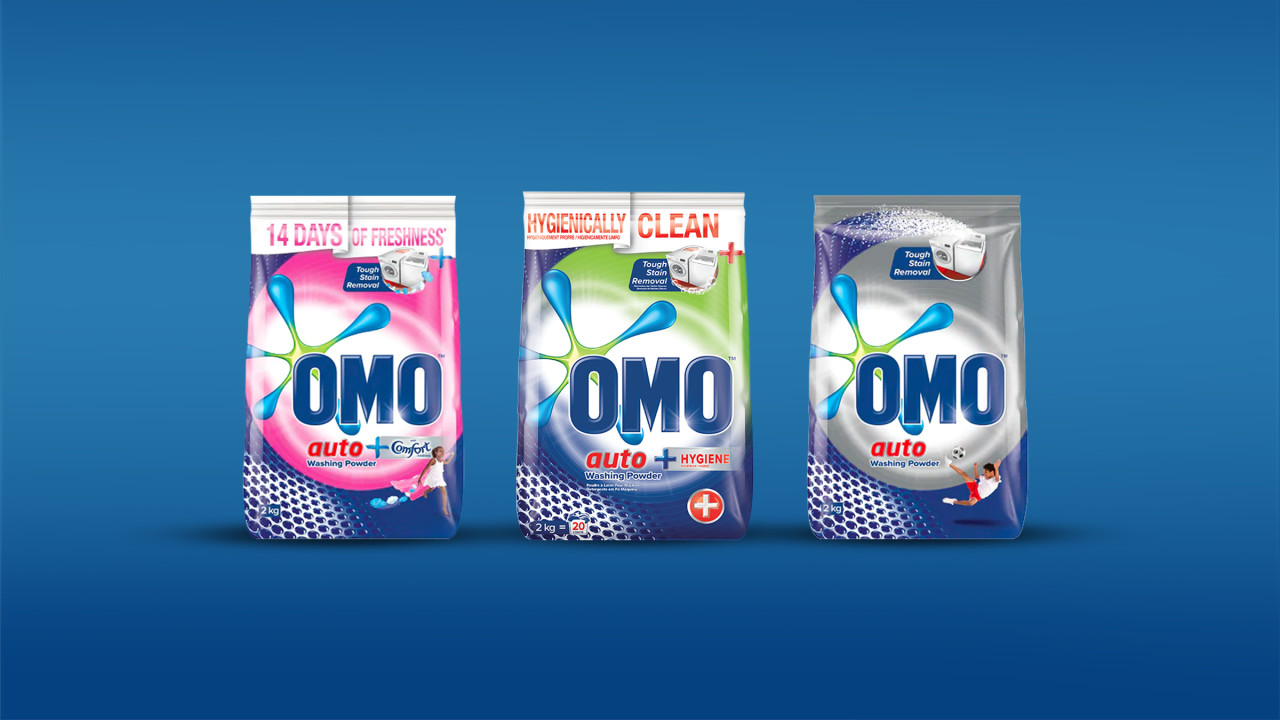 OMO auto powder range lined up on a blue background